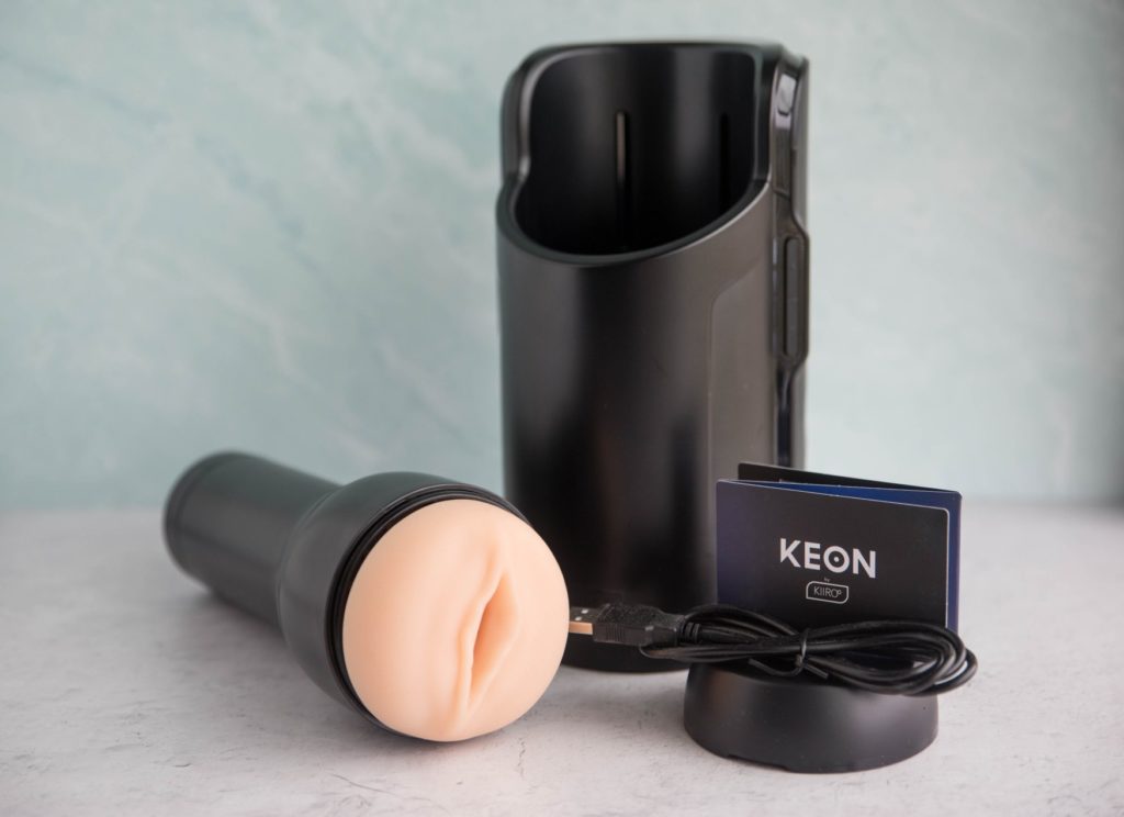 RealFeel Stroker and KIIROO KEON itself next to other items it comes with for the KIIROO KEON Review