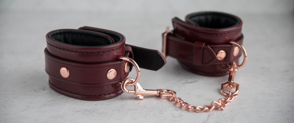Liebe Seele Wine Red Cuffs review. The two cuffs sit next to one another with the contrasting, rose gold metal hardware looking stunning next to the color of the cuffs.