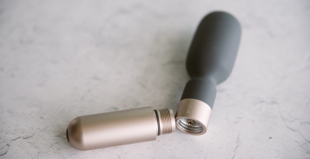 Love Not War Koi review: The battery base (which also functions as the vibrator's handle) is unscrewed from the tip of the wand massager. This angle shows the interior area of both halves of the toy including the screw-in design as well as the rechargeable port for the handle.