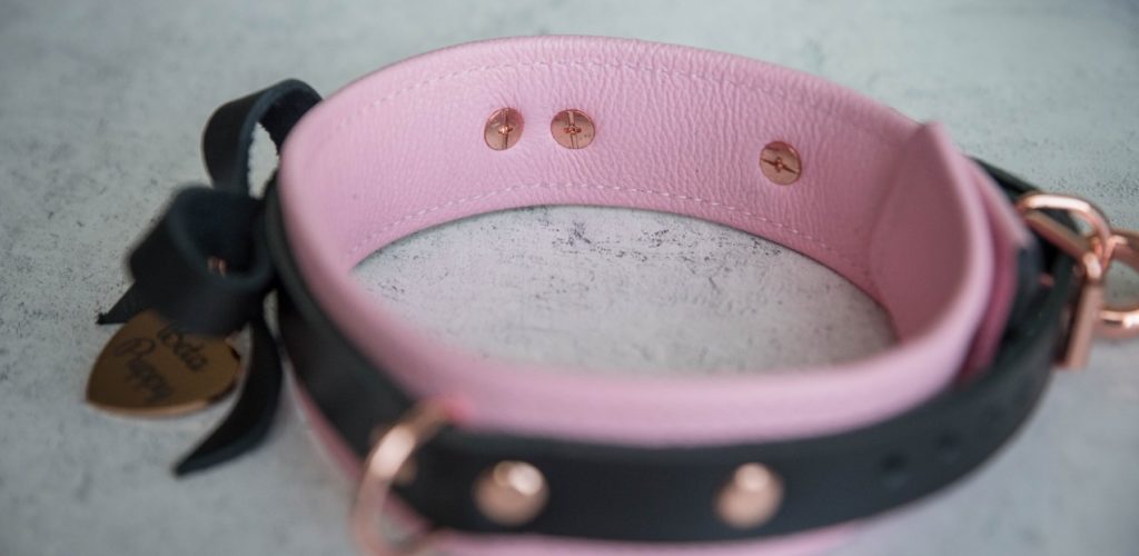 Close-up of the interior of the pink collar. This angle showcases the textured leather interior that is interrupted with the occasional backside of a rivet. Mercy Industries Collar Review image.