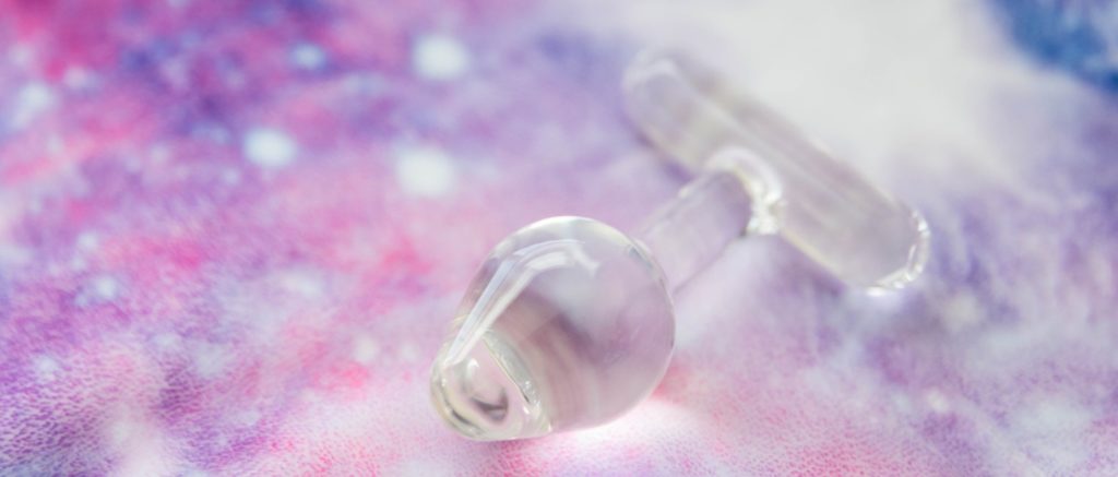 The Crystal Delights T Handle Plug lays out on a galaxy-colored, soft-looking blanket. It is naturally lit and see-through and clear. For my Crystal Delights T Handle Plug review.