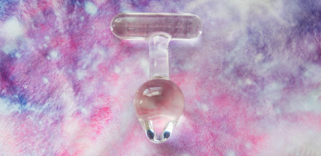 The Crystal Delights T Handle Plug lays out on a galaxy-colored, soft-looking blanket. It is naturally lit and see-through and clear. For my Crystal Delights T Handle Plug review.
