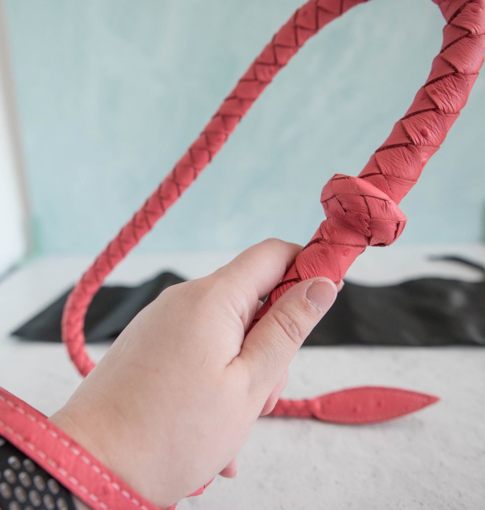 My hand wrapped around the Angel's Kiss Whip handle. There is clearly another inch left of space. Someone with a larger handle could still comfortably wield this. Image for Liebe Seele Angel's Kiss Bullwhip review.