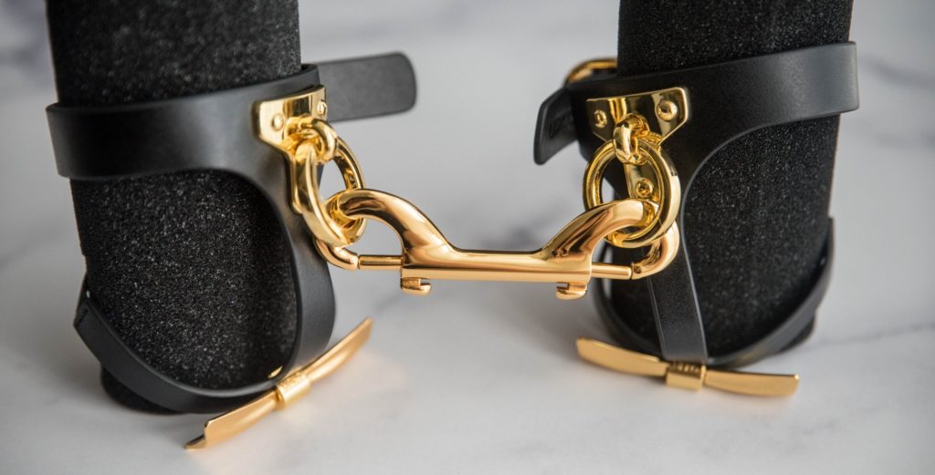 Close-up of the double-sided gold clip that comes with the ankle cuffs. It is clipped onto both cuffs to show how it connects the two. UPKO Butterfly Effect Ankle Cuffs review image.