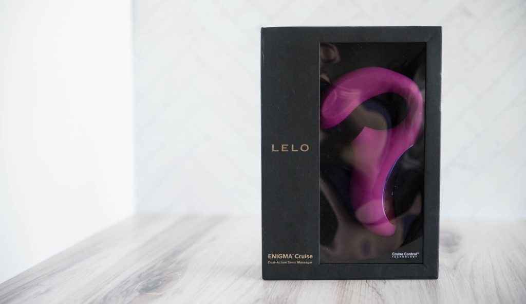 Packaging for the LELO Enigma Cruise against a white background. There's a reflective see-through window that allows someone to see the toy inside the otherwise all-black box.