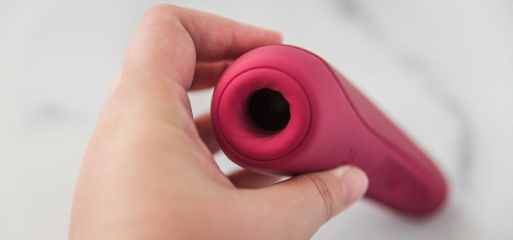 A top-down view of the hollow tip of the Satisfyer Curvy 1. This angle really showcases how "thick" the tip of the vibrator is with a lot of additional material around the hollow tip itself.