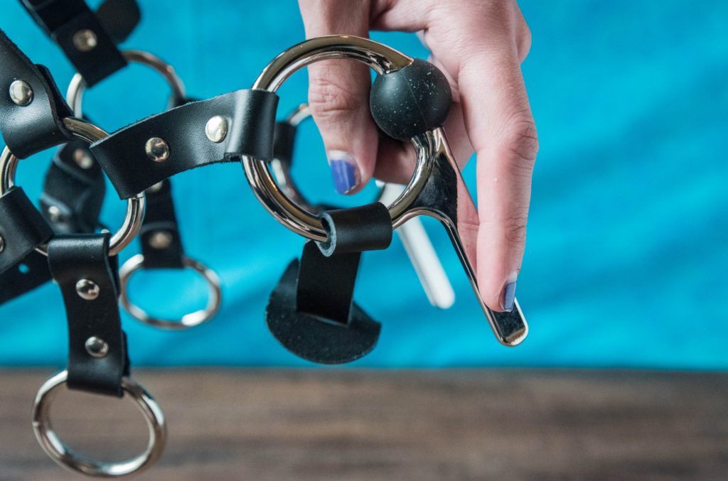 Close up of the two large, pronged O-rings that support the silicone bit. They're next to a person's hand to show how large they are. Meo.de Pony Bridle Head Harness review.