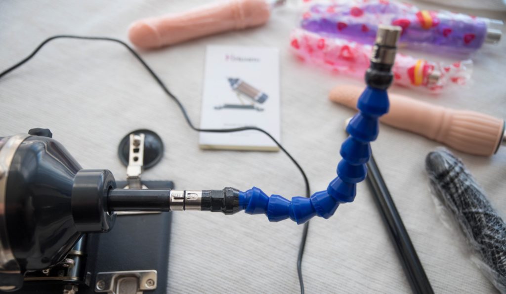 The bendable extender attached to the sex machine without a dildo on the other side. It is very bendable, and it is shown in a J-like shape, holding its own shape, without my hands to help hold it there. For Hismith Sex Machine Review 3XLR version.