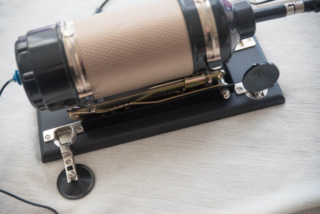 Close-up of the four fold-up "feet" on the sex machine. One of the sets of feet is folded down to press against the floor underneath it while one of the feet is folded upright to show how they can fold around. For Hismith Sex Machine Review 3XLR version.