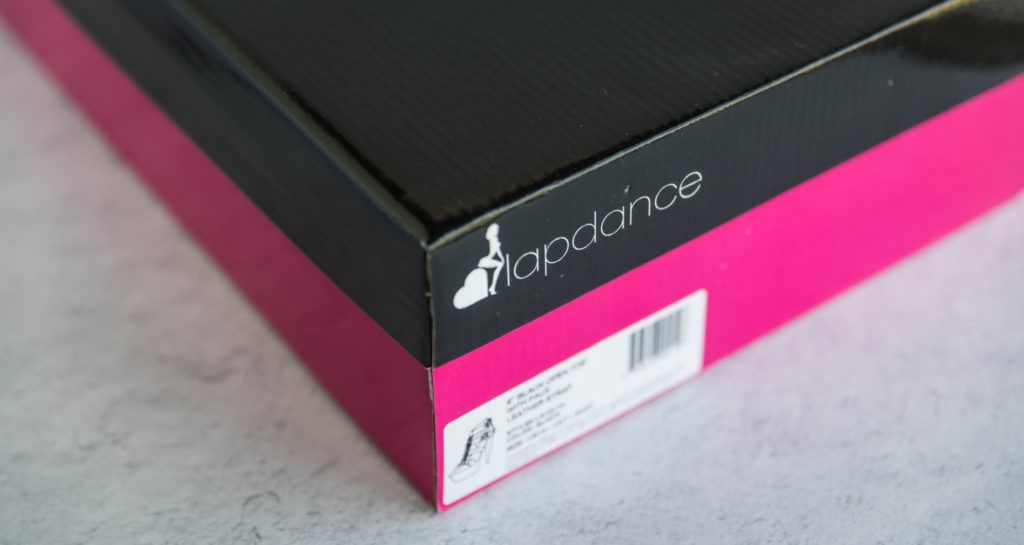 Close up of the box the Lapdance heels come in. It's standard shoebox that's bright pink on the bottom with a black lid. It really stands out in a shoe collection. For my Lapdance Open Toed Studded Platform Heels review.