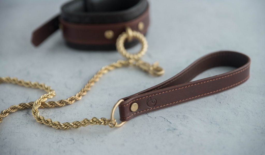 Close-up of the leash handle. It's a brown leather with sewn edges with a color-matched thread. The Liebe Seele logo is etched into the surface of the leash handle.