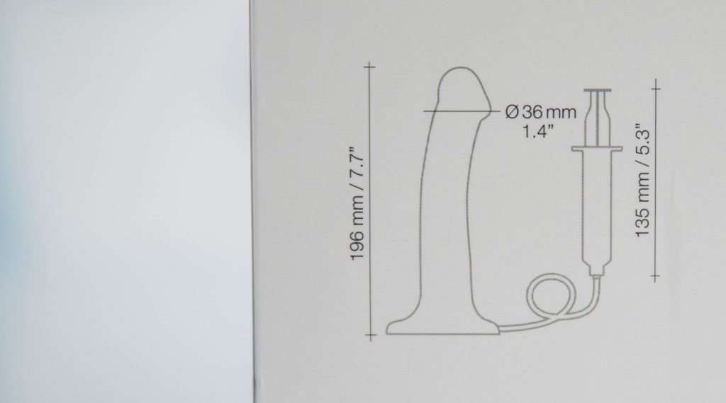 Close up of the measurements of the toy printed on an outline of the dildo and the syringe. The dildo is 7.7" total length with a diameter of 1.4" near the head. The syringe is 5.3" in length.