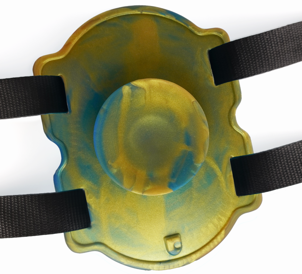 Photo of the Uncover Creations Suction Cup Mount. It looks like a long, silicone slab with a suction cup built into it. Four straps protrude from the four corners of the silicone platform that allow it to wrap around something. For my how to use sex toys hands free article. 