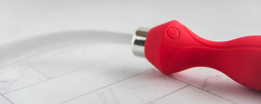 Close-up of the anal plug's base. This showcases the single power/control button etched into the single as well as the area where the fiber optic cabeling protrudes from the base of the plug. For my Inyarose Luminious Fiber Optic anal plug review.