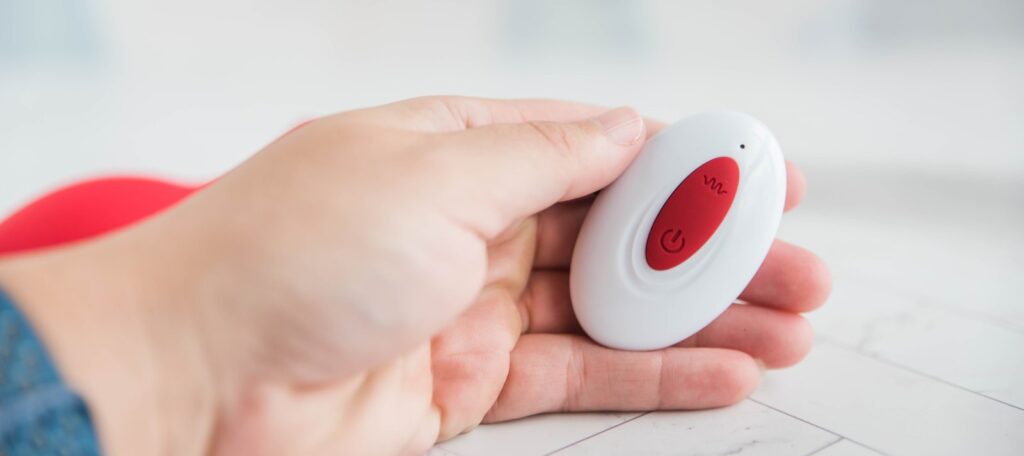 My hand holds the wireless remote control for the plug. It's an oval shape with two buttons in the middle of the plastic, white remote. It is less than 3 fingers' width and it looks like it could easily be hidden in a closed fist. For my Inyarose Luminious Fiber Optic anal plug review.