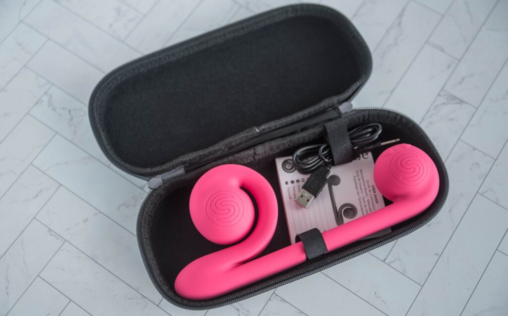 The Snail Vibe snugly tucked away in the included zippered carrying case. There are Velcro ties that secure the vibrator and charger in place and keep them from sliding around.