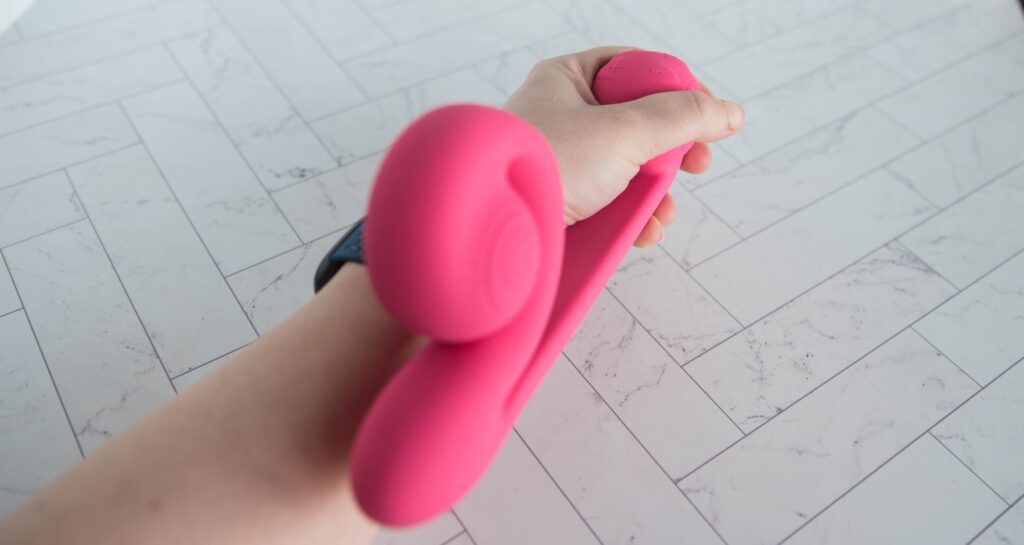 My hand holds the ball "handle" of the vibrator where the controls are with the insertable shaft closest to the camera like the vibrator would be held for use. For my Snail Vibe review article.