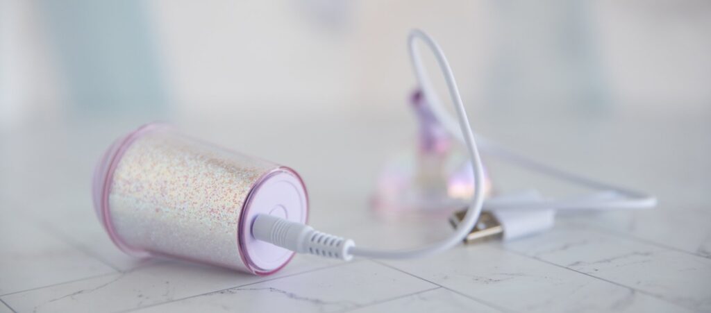 The charging cable plugged into the base of the vibrator. It's a pin-style charger that plugs into the toy. For my BeYourLover Joy Cup review.