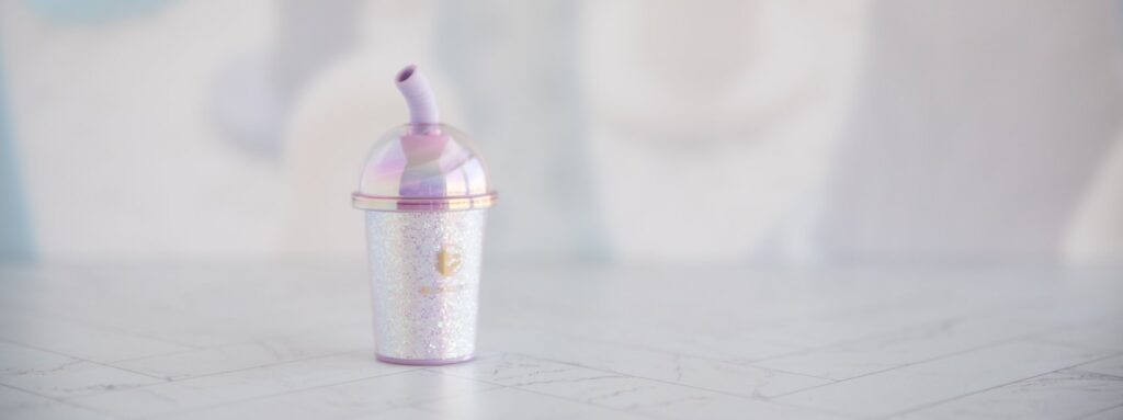 The Joy Cup vibrator sits out on a flat surface. It looks very small.