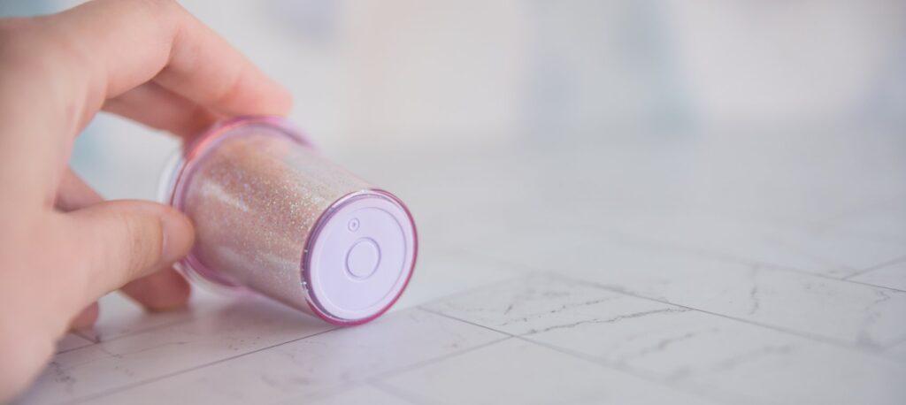 Close up on the bottom of the vibrator. There's a single unmarked circle on it that functions as the control button for the toy. For my BeYourLover Joy Cup review.