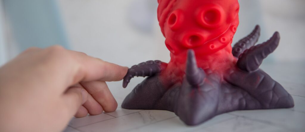 My finger lightly pushes down one of the small tentacles at the base of the dildo. It folds over easily with a super soft design. For my Juliet Toys Starfish dildo review.