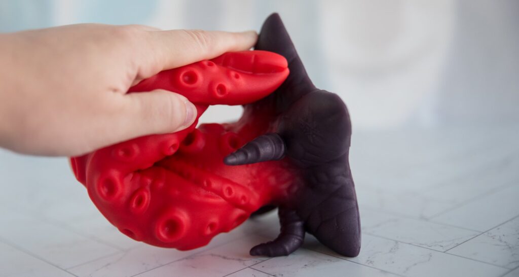 I fold the dildo in half. The dildo's tip touches the base of the dildo. It basically folds in half.