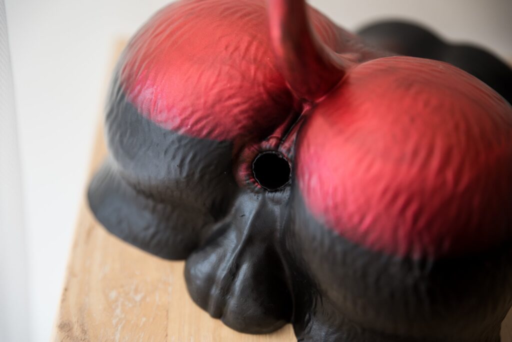 Close-up on the anal entrance and the booty cheeks of the Naberus dog fleshlight. The silicone has "fur" texturing to it while the anal entrance has a ring of musculature around it.