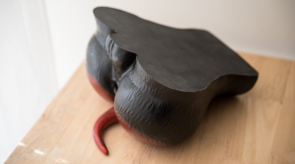 The Naberus laid upside down, showcasing how the underside of this dog fleshlight is completely flat and smooth with no texturing. This makes it easier for it to stay in place and avoid sliding back and forth during use.