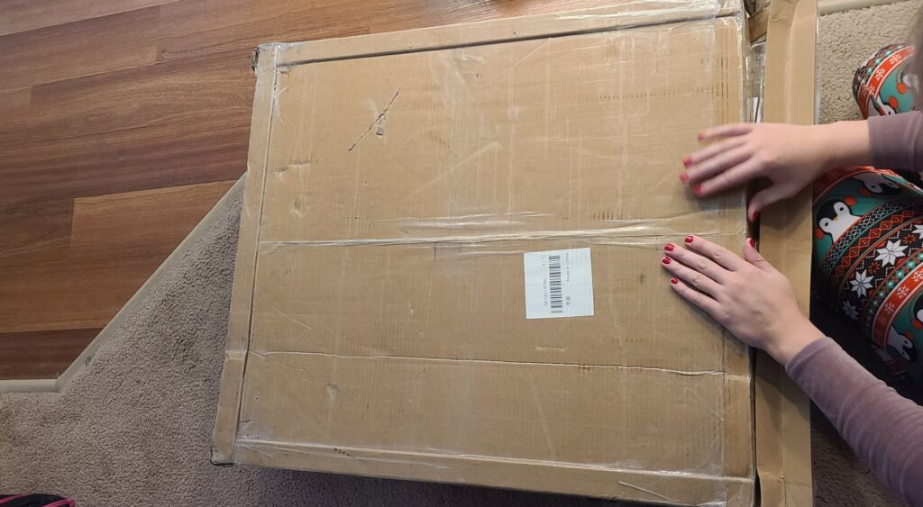 The packaging this sex furniture comes in. It's a very large, flat box, in plain brown that looks a little beat up.