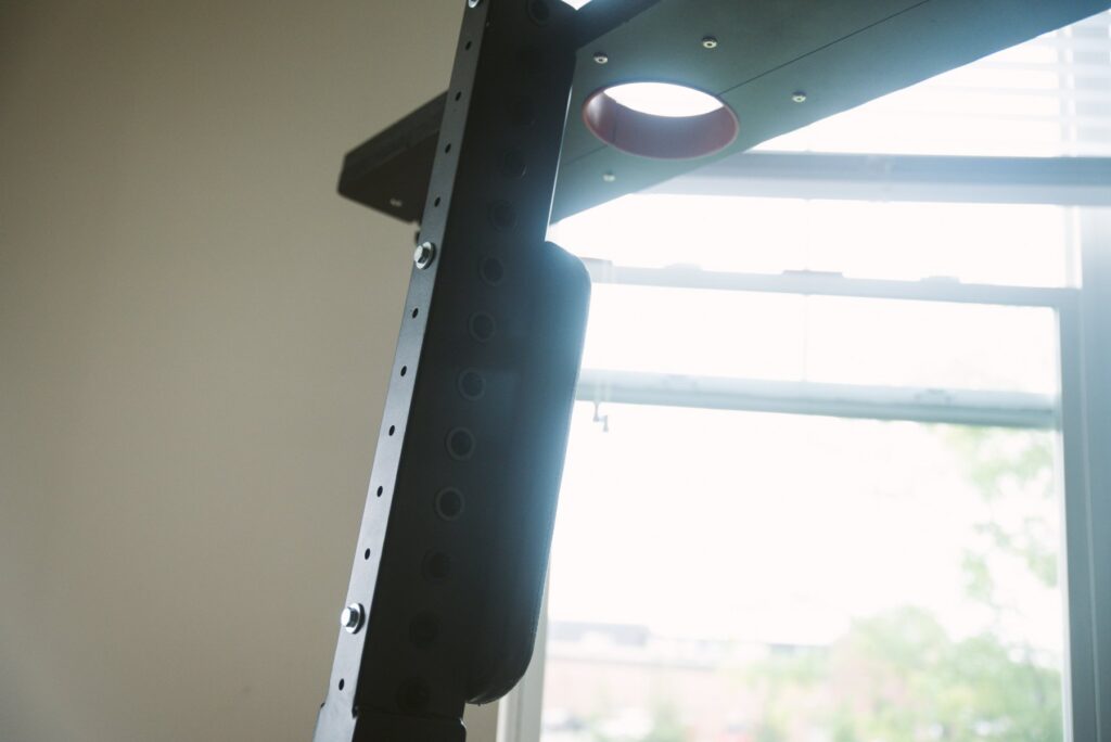 Close-up on the backside of one of the L-shaped hinges, showcasing how bolts fit through the metal to attach the chest pad anywhere you want it. There are lots of holes throughout the metal, allowing the chest pad to move virtually anywhere you want. For my Fetdom Multi-Position Floating Stockade Pillory Review.