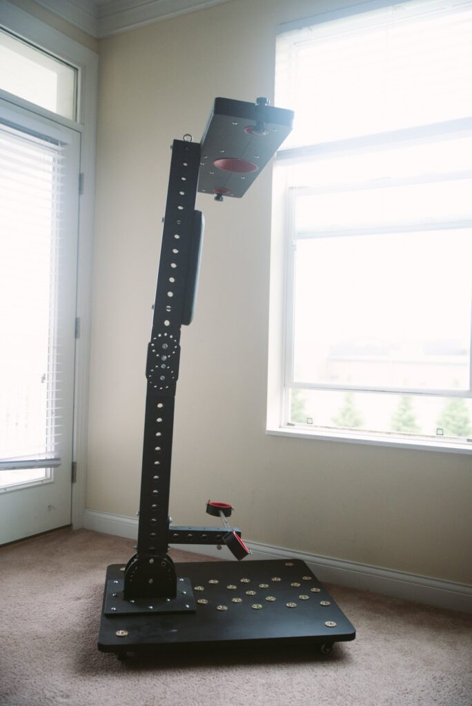 The sex furniture is shown standing up at its tallest. All of the L-shaped joints have been fully straightened, and the furniture looks like a large "T" on top of a flat platform. For my Fetdom Multi-Position Floating Stockade Pillory Review.
