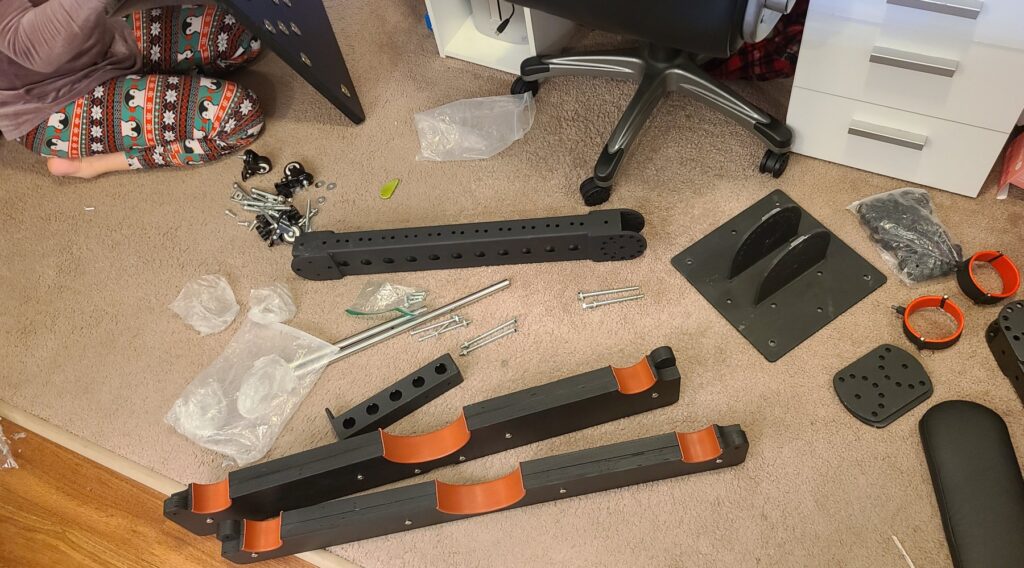 Items from the furniture strewn around on the floor, showcasing all of the pieces it comes in.