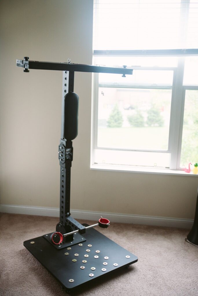 The sex furniture is shown standing up at its tallest. All of the L-shaped joints have been fully straightened, and the furniture looks like a large "T" on top of a flat platform. For my Fetdom Multi-Position Floating Stockade Pillory Review.