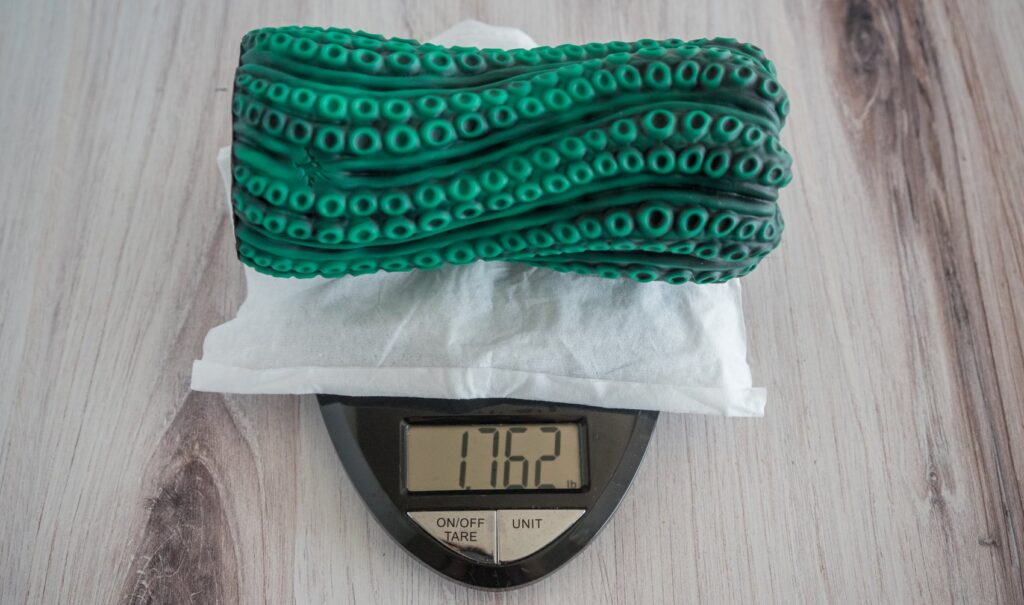 The Vortima sits on a kitchen scale. The scale's weight is visible. It is 1.762 pounds. For my Nothosaur Vortima review.