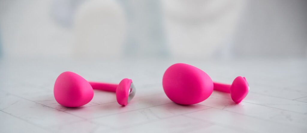 Front view of Lovense Lush Mini (on the left) and Lush 4 (on the right) next to one another. Both look virtually the same except the Lush Mini has a smaller insertable size. The insertable "shaft" is triangular in size with a swell towards the innermost spot that'll make for better g-spot contact.