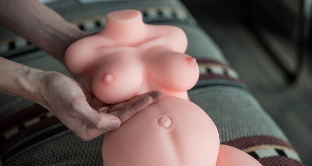 A person is cupping one of the Marissa breasts. The breast looks pretty small in their hand, but it's still enough to be squeezable. For my MRLSexDoll Marissa review.