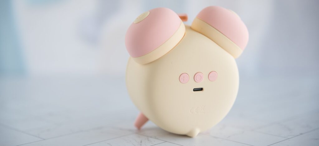 Backside of the alarm clock, showcasing the three buttons and the charging port on the backside of the clock.