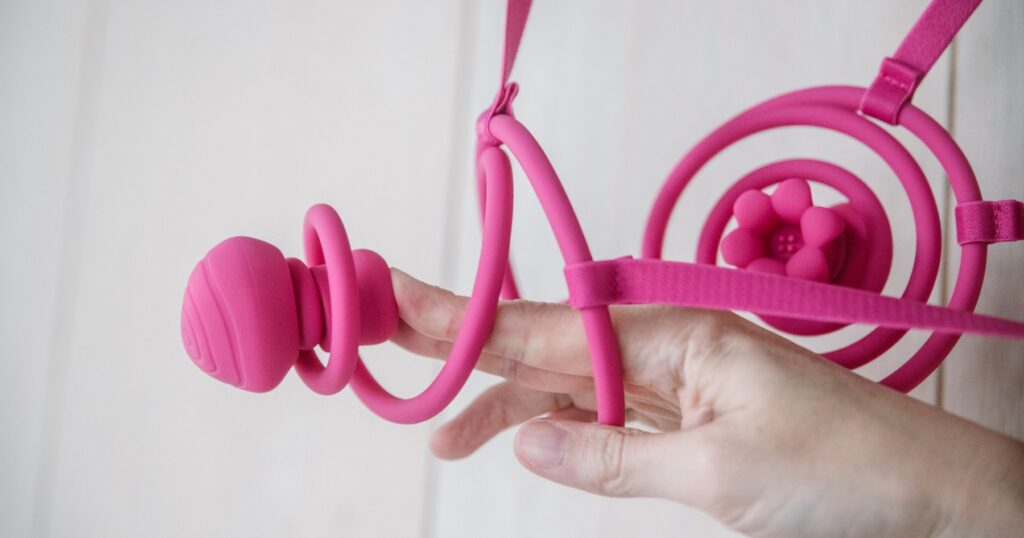 My hand pushes the vibrator through the center of the circle exterior, showcasing how far the "spring" will let the vibrator move away from the circle. For my VVD Vkini review.