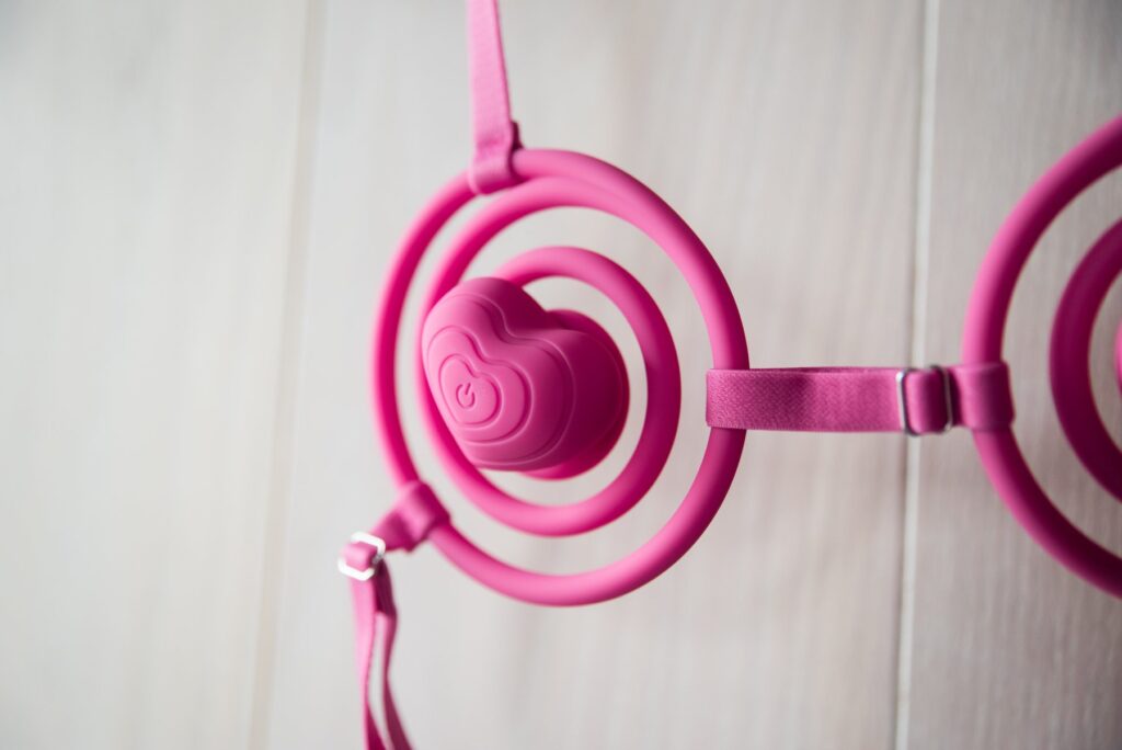 Close-up on the viewer's side of the Vkini, showcasing the power button that's in the center of the heart on both of the nipple vibrators.