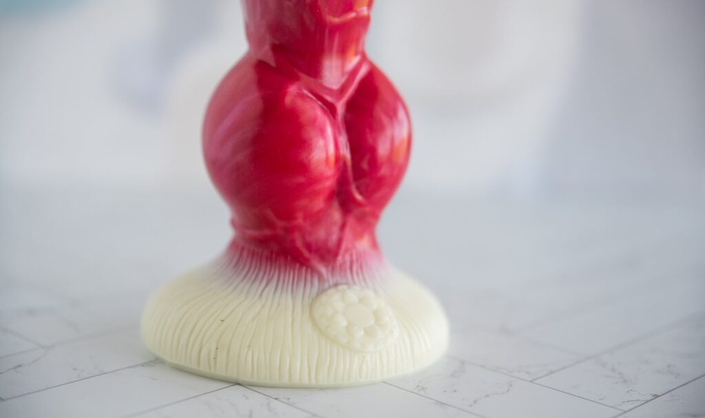 Close-up on the base of the toy, showcasing the logo and the "hair" texturing etched into the base. For my Juliet Toys PupJoy review.