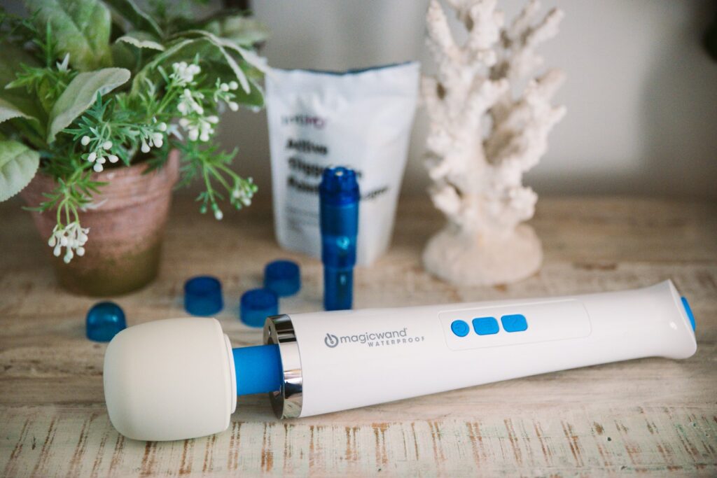 The Magic Wand shown in front of the included Active Trigger Pin Point Massager and its bag included with the IntiMD purchase. For my Magic Wand Waterproof review.