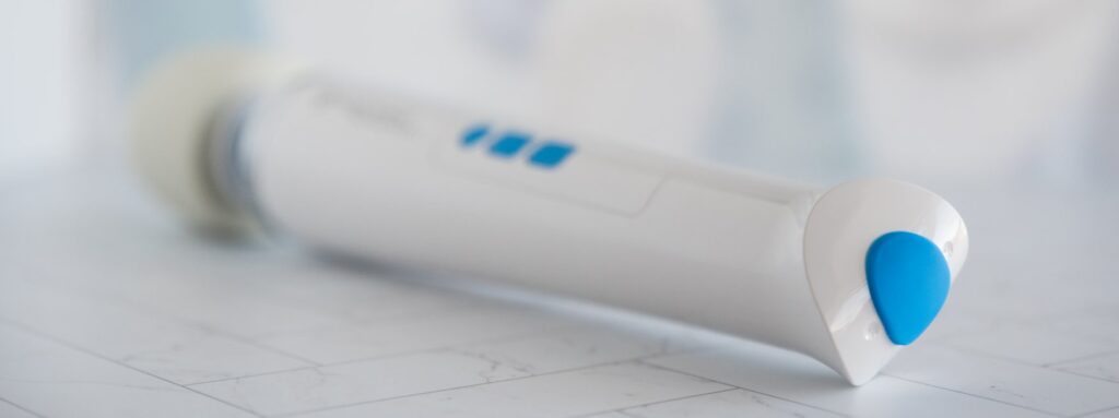 A close-up on the base of the Magic Wand Waterproof. The "waterproof" cap is plugged into its charging port, showcasing how it fully removes from the base of the wand. For my Magic Wand Waterproof review.