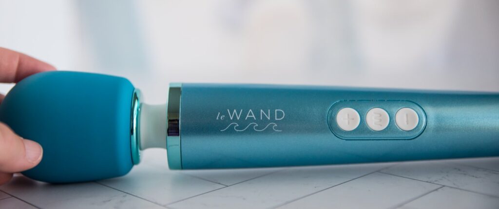 Close-up of the Le Wand Waterproof logo that's etched into the surface of the wand. There's also the three easy-see buttons from here.