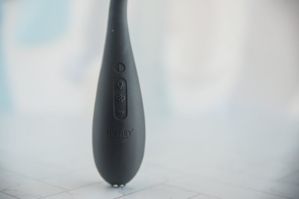 Close-up of the four buttons on the shaft of the AIRA. There's an emergency deflate, inflate, vibrations, and power button. For my Honey Play Box AIRA review.