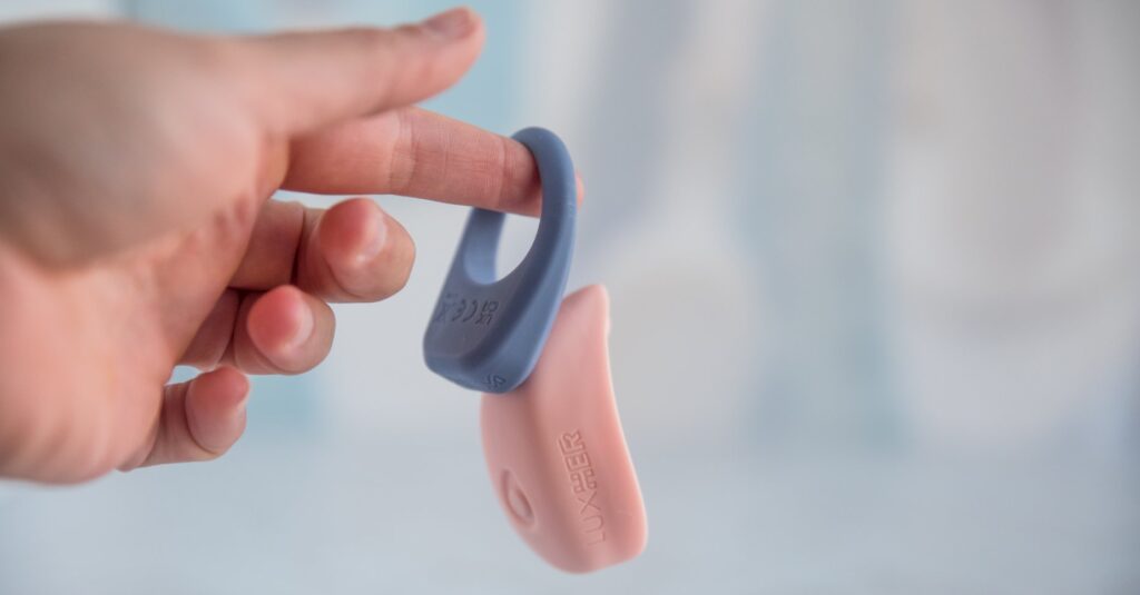 The LuxHim is hanging off my finger. The LuxHer is hanging off the LuxHim, the magnetic connection strong enough to hang the vibrator. For my Luxus review.