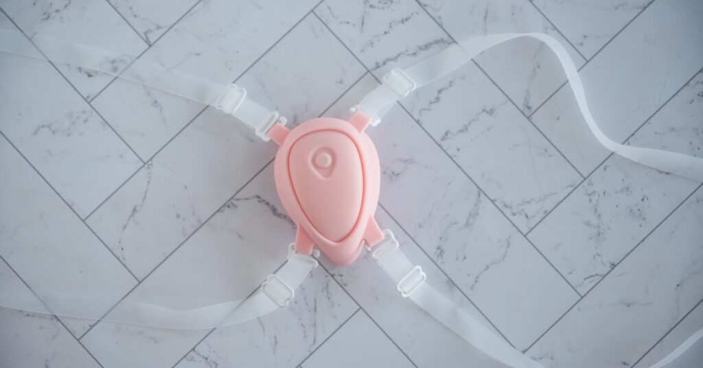 The LuxHer vibrator is in the holster of the Luxus harness, showcasing how the harness fits the LuxHer vibrator.