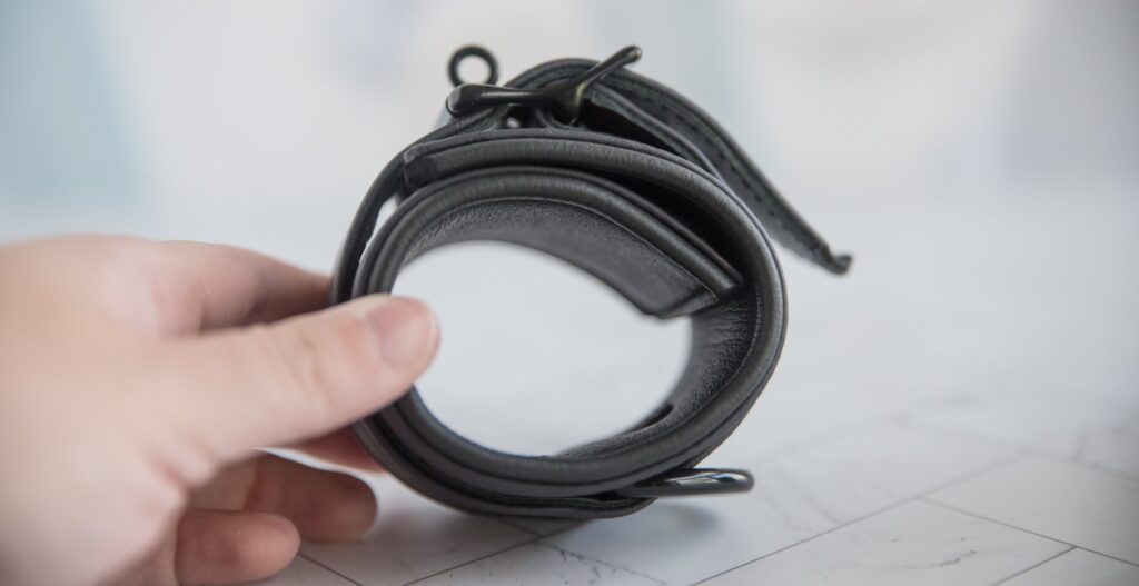 I tilt the side of the cuff towards the camera, showing off the thick fabric of the cuff in addition to the multi-layer design around the buckling area. For my MEO.de Lockable Chicago Neoprene Restraints review.