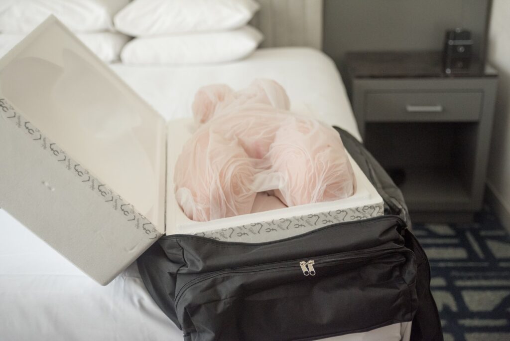 The black storage bag is unzipped. The styrofoam shell is inside the black bag but opened up, showcasing the doll sitting in the styrofoam shell. For my Tantaly Hannah review.