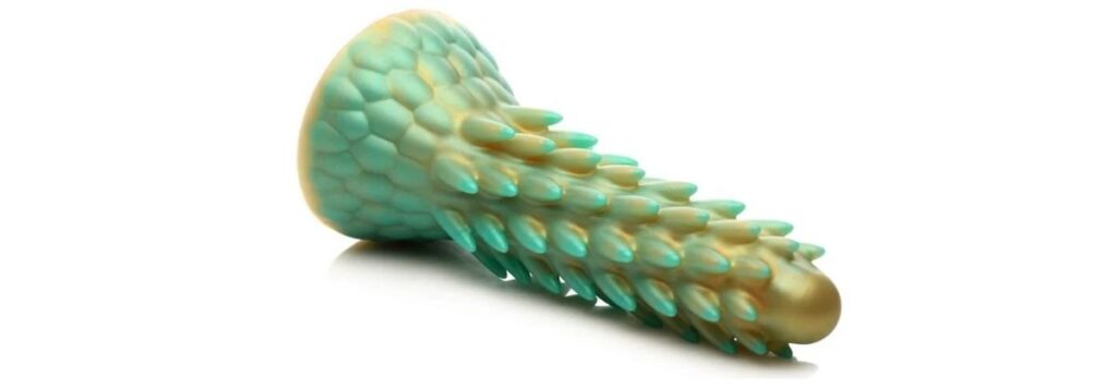 Creature Cocks Stegosaurus dildo. It's a green and yellow silicone dildo with lots of spikes up the entirety of the shaft. 