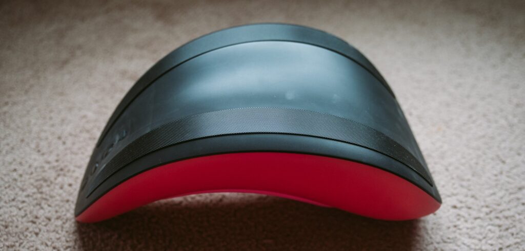 The toy is filpped outside down, showcasing the bottom. Most of it is a black, shiny plastic except two strips of anti-skid material. For my VVD Rider Desire review.